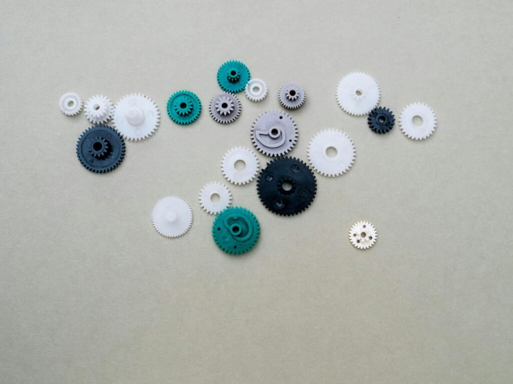 A collection of colorful plastic gears arranged on a plain surface, ideal for mechanical or DIY concepts.